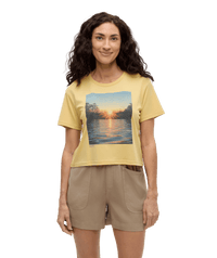 Yellow crop t-shirt with lake sunset graphic print, front view on model