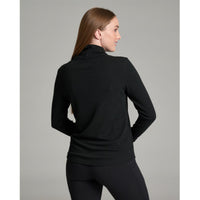 Black ribbed turtleneck pullover, back view on female model with leggings