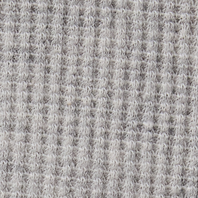 Close-up swatch of heather grey waffle-knit cotton fabric showing textured grid pattern
