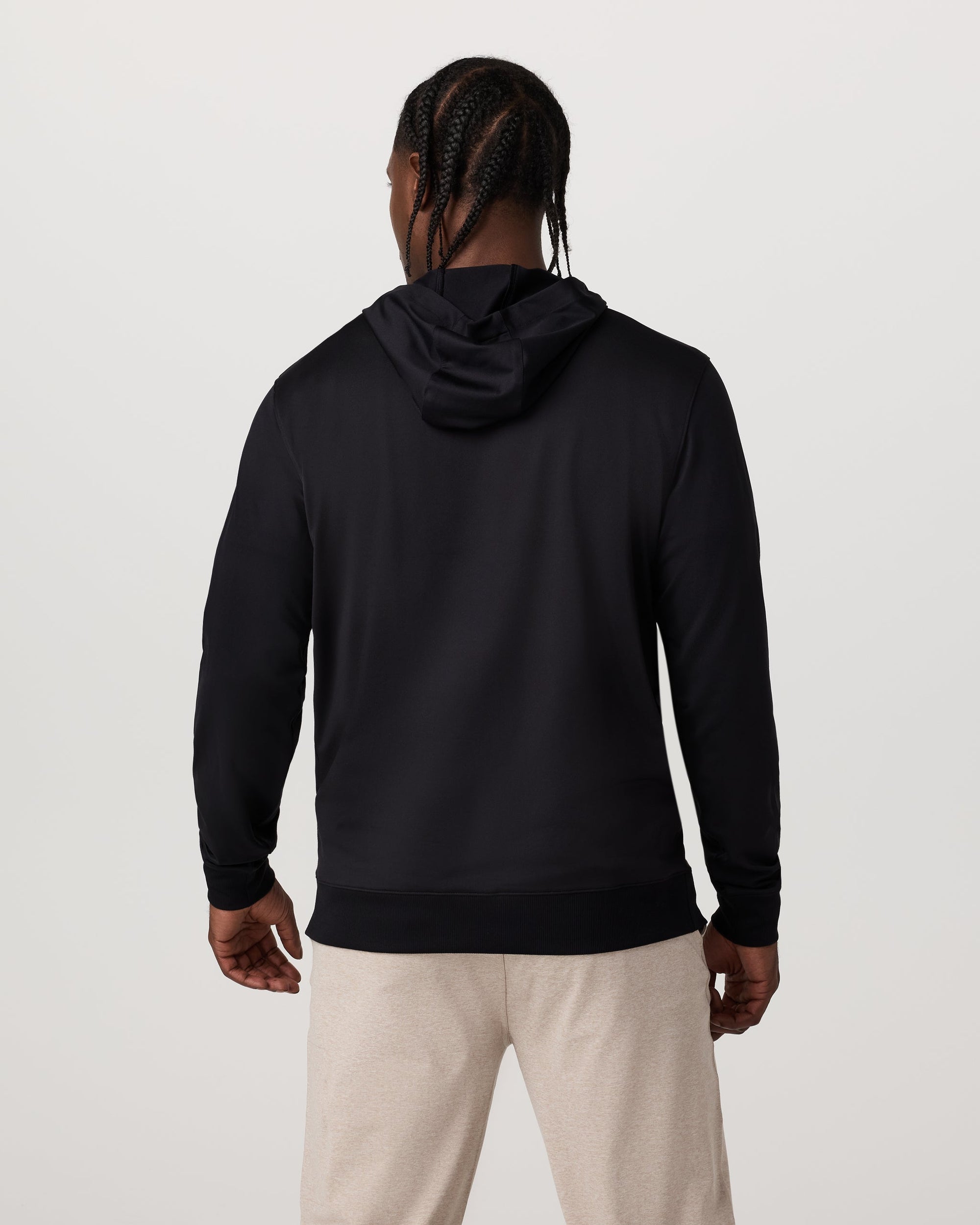 Men's black pullover hoodie, back view, worn with light gray sweatpants