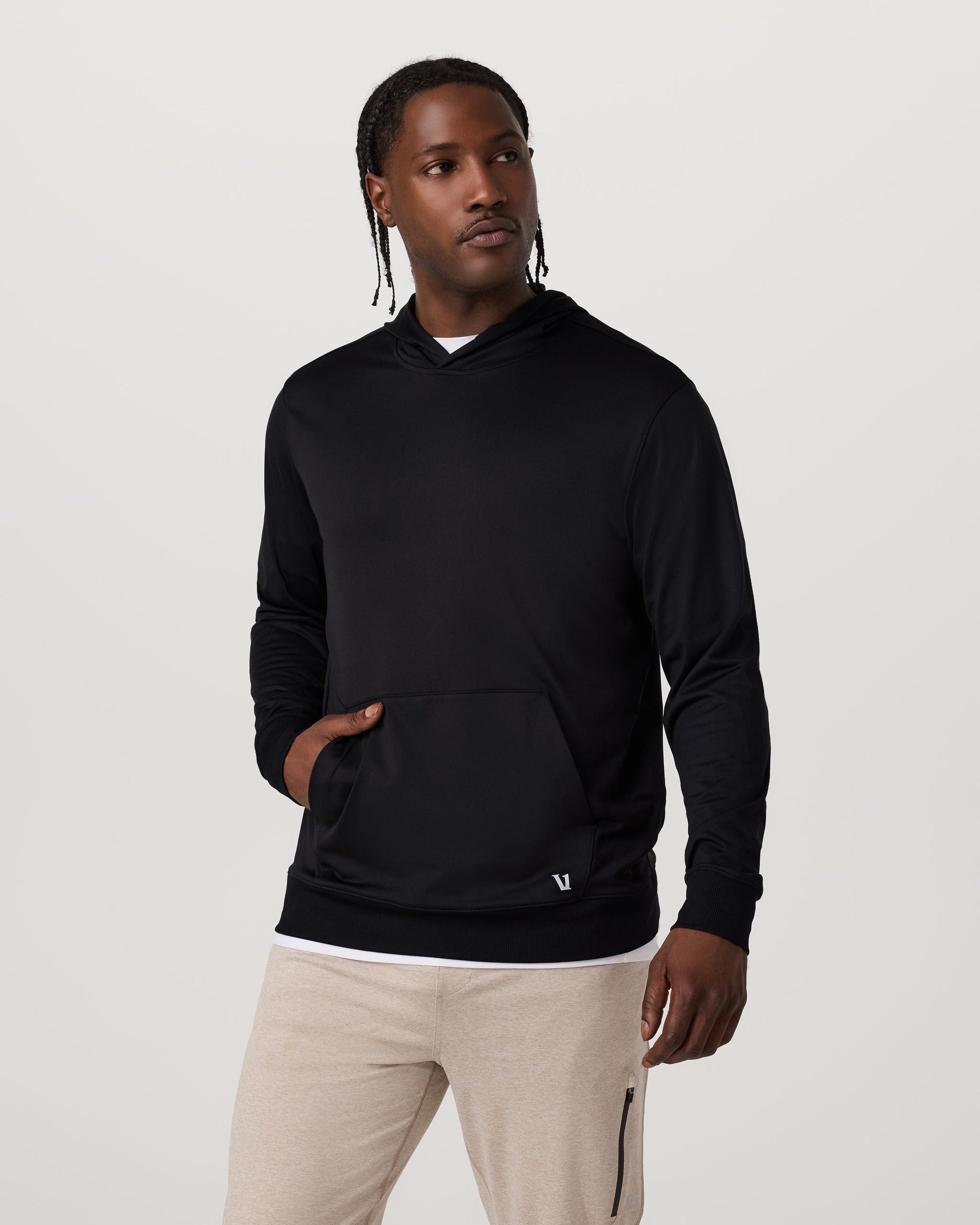 Men's black pullover hoodie with kangaroo pocket, front view on model