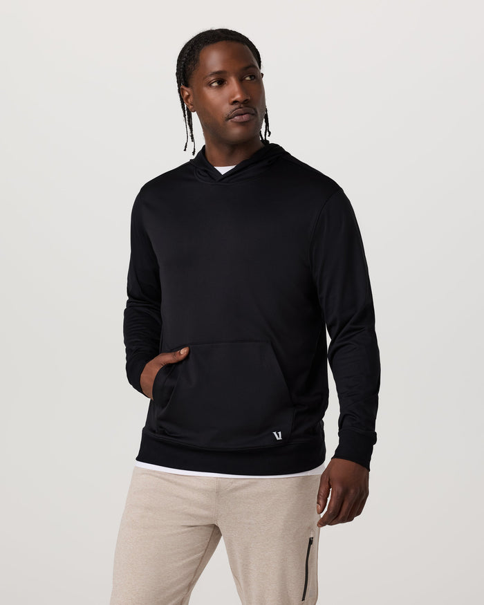Men's black pullover hoodie with kangaroo pocket, front view on model