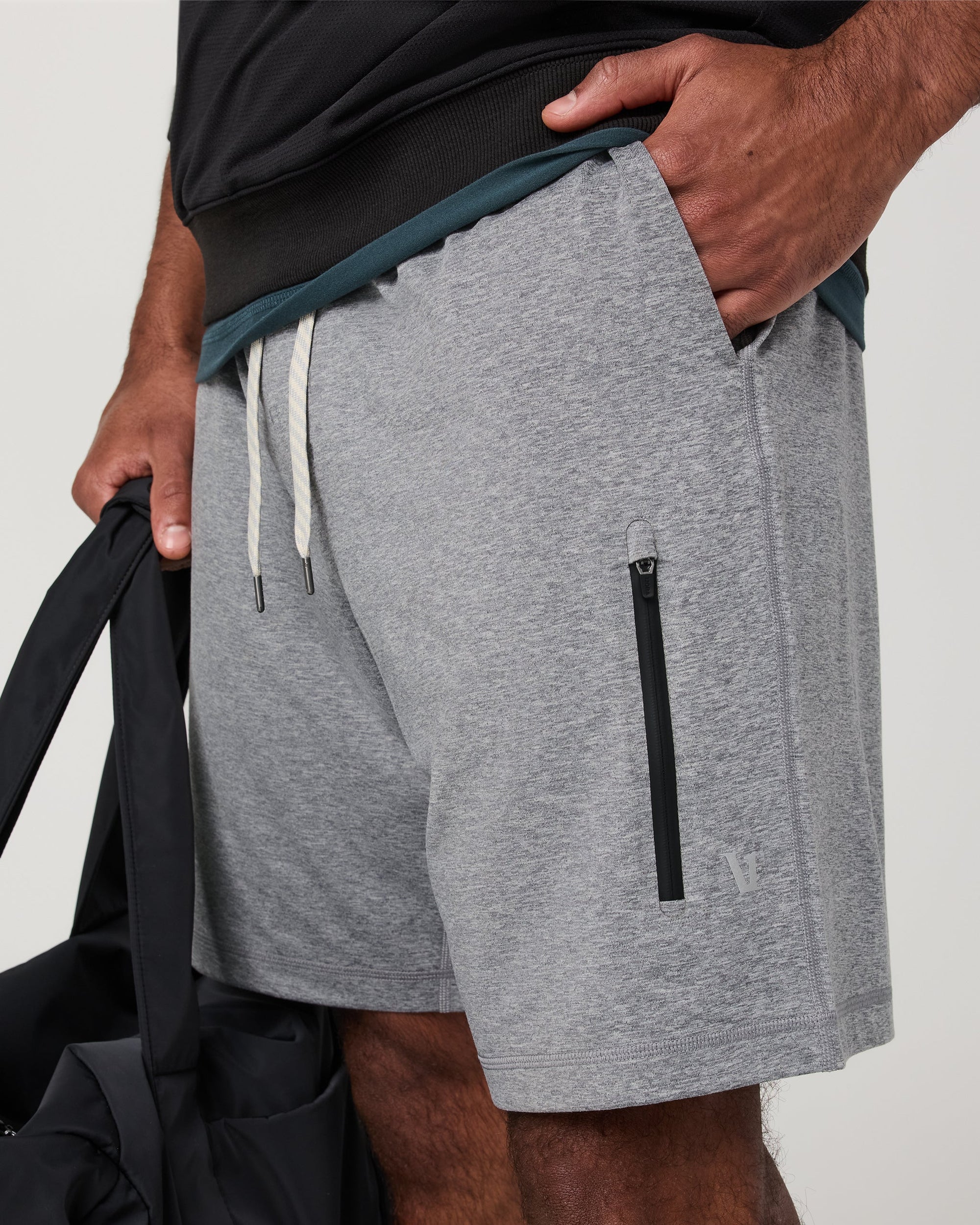 Men's grey heather performance shorts detail shot showing zip pocket and drawstring waistband