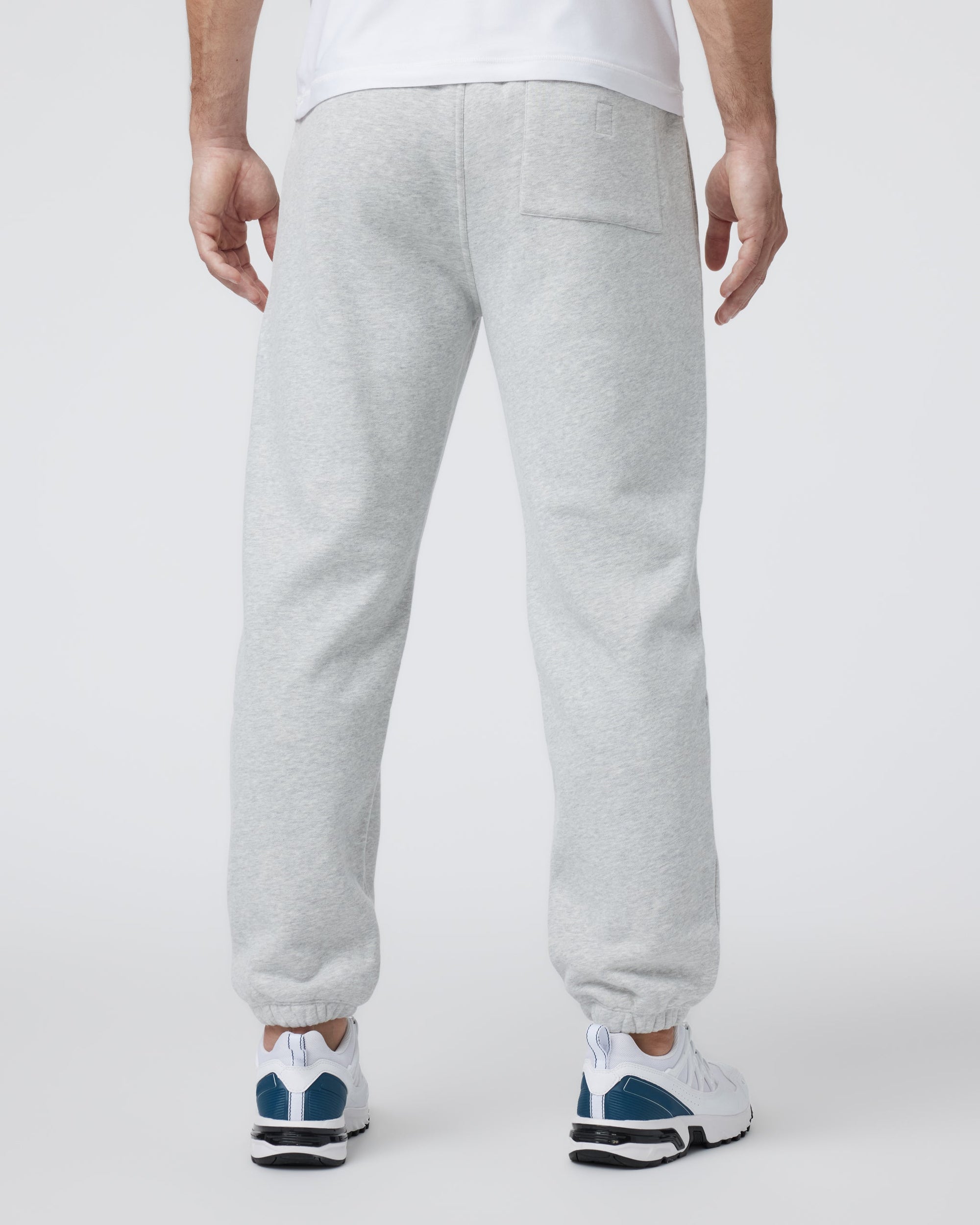 Men's grey fleece sweatpants with elastic cuffs and back pocket, rear view
