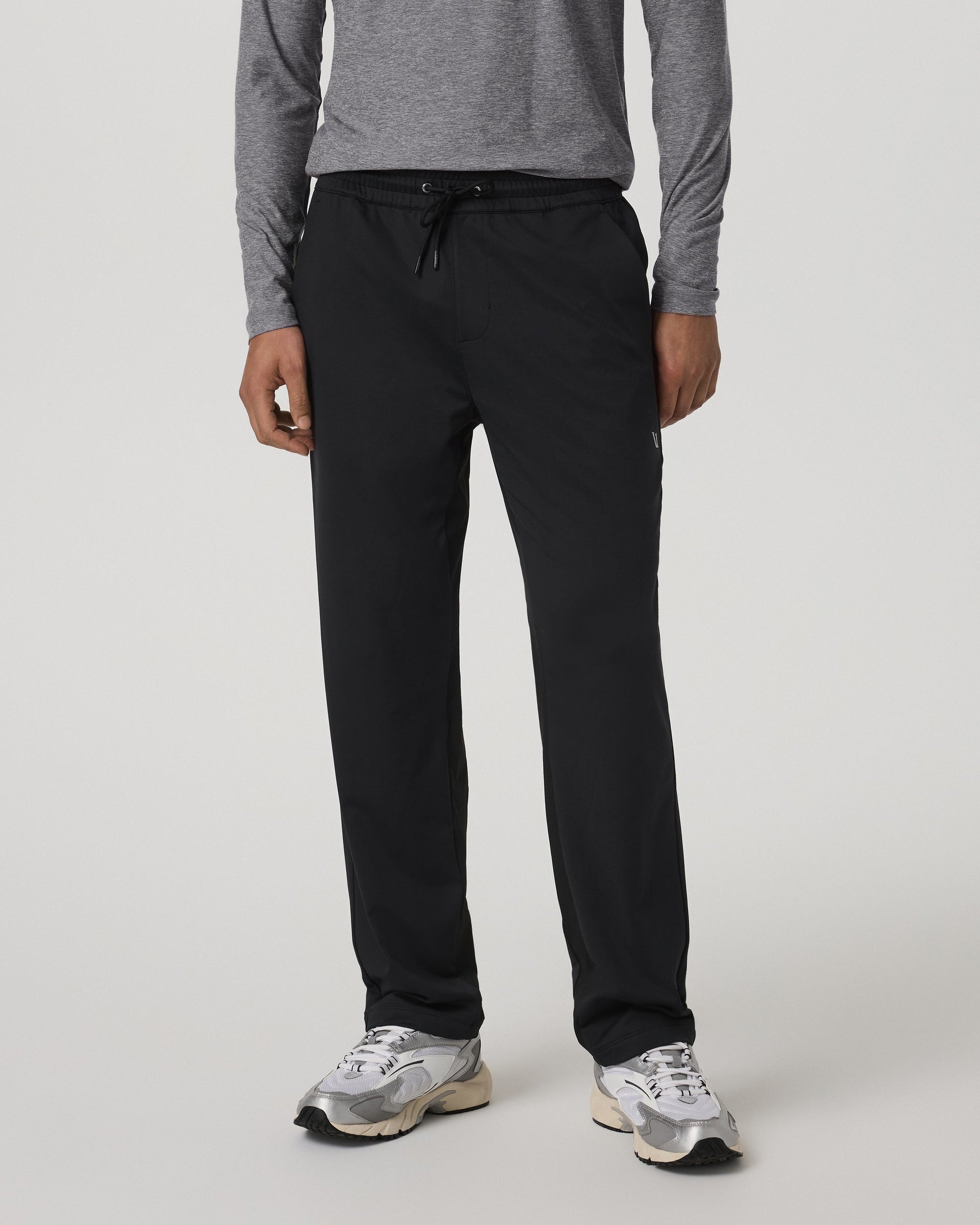 Men's black straight-leg track pants with drawstring waist, front view on model
