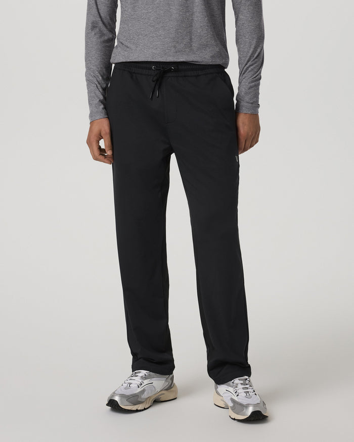 Men's black straight-leg track pants with drawstring waist, front view on model