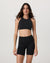 High neck sports bra in black, front view on model, sleeveless with racerback style