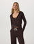 Women's cropped zip-up hoodie in dark brown, front view, paired with matching wide-leg pants
