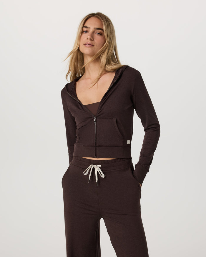 Women's cropped zip-up hoodie in dark brown, front view, paired with matching wide-leg pants