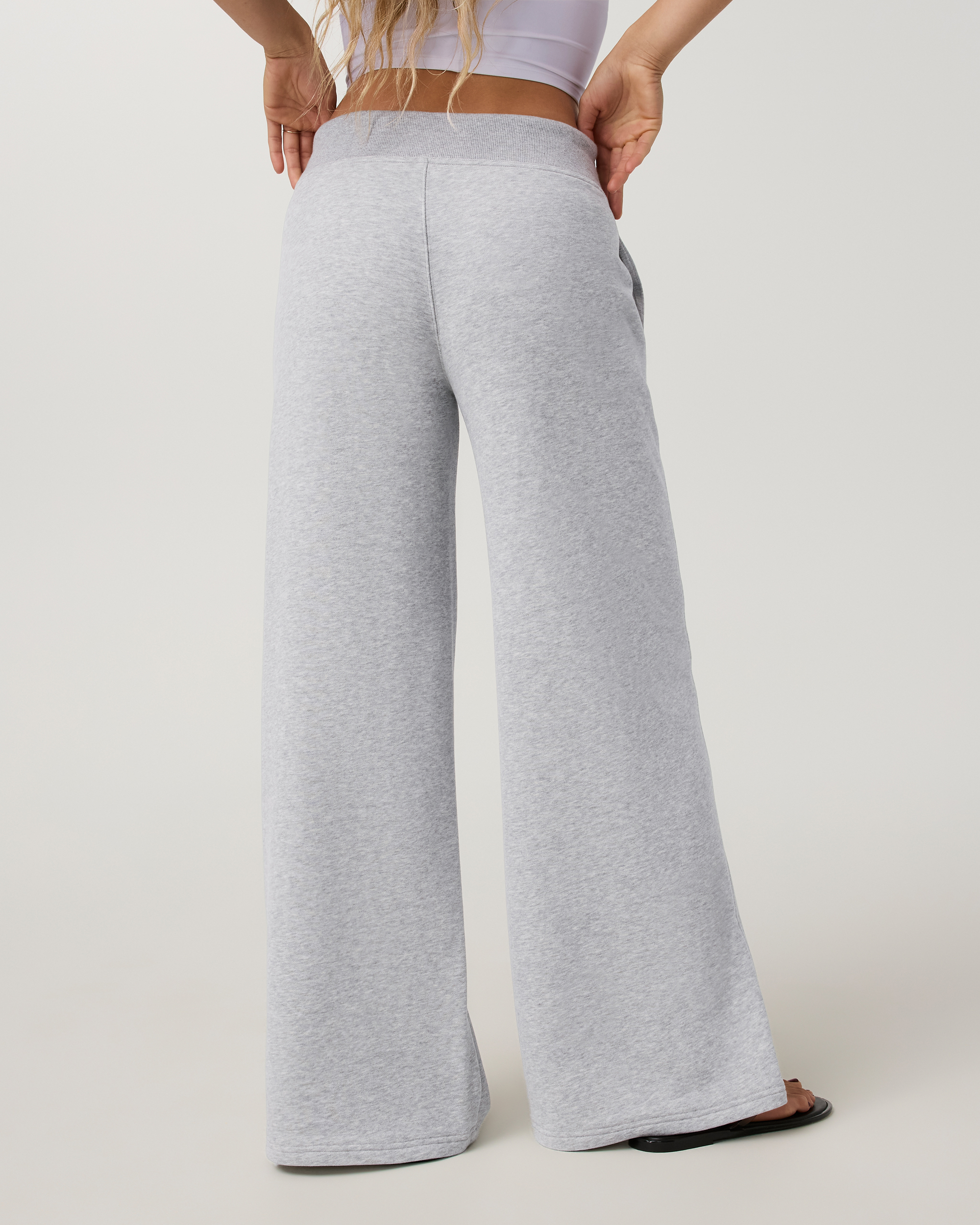 Wide-leg sweatpants in heather grey, back view on model, mid-rise waistband