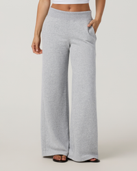 Women's wide-leg sweatpants in heather grey with mid-rise waistband and side pockets, front view