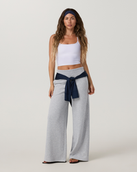 Women's wide-leg sweatpants in heather grey with fold-over waistband, full-length front view on model