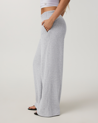 Wide-leg high-rise grey sweatpants with center seam detail, side view on model