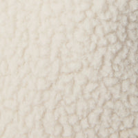 Close-up swatch of cream-colored sherpa fleece fabric with textured, curly pile surface