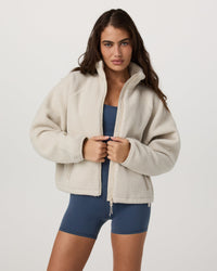 Women's sherpa fleece zip-up jacket in off-white, front view on model