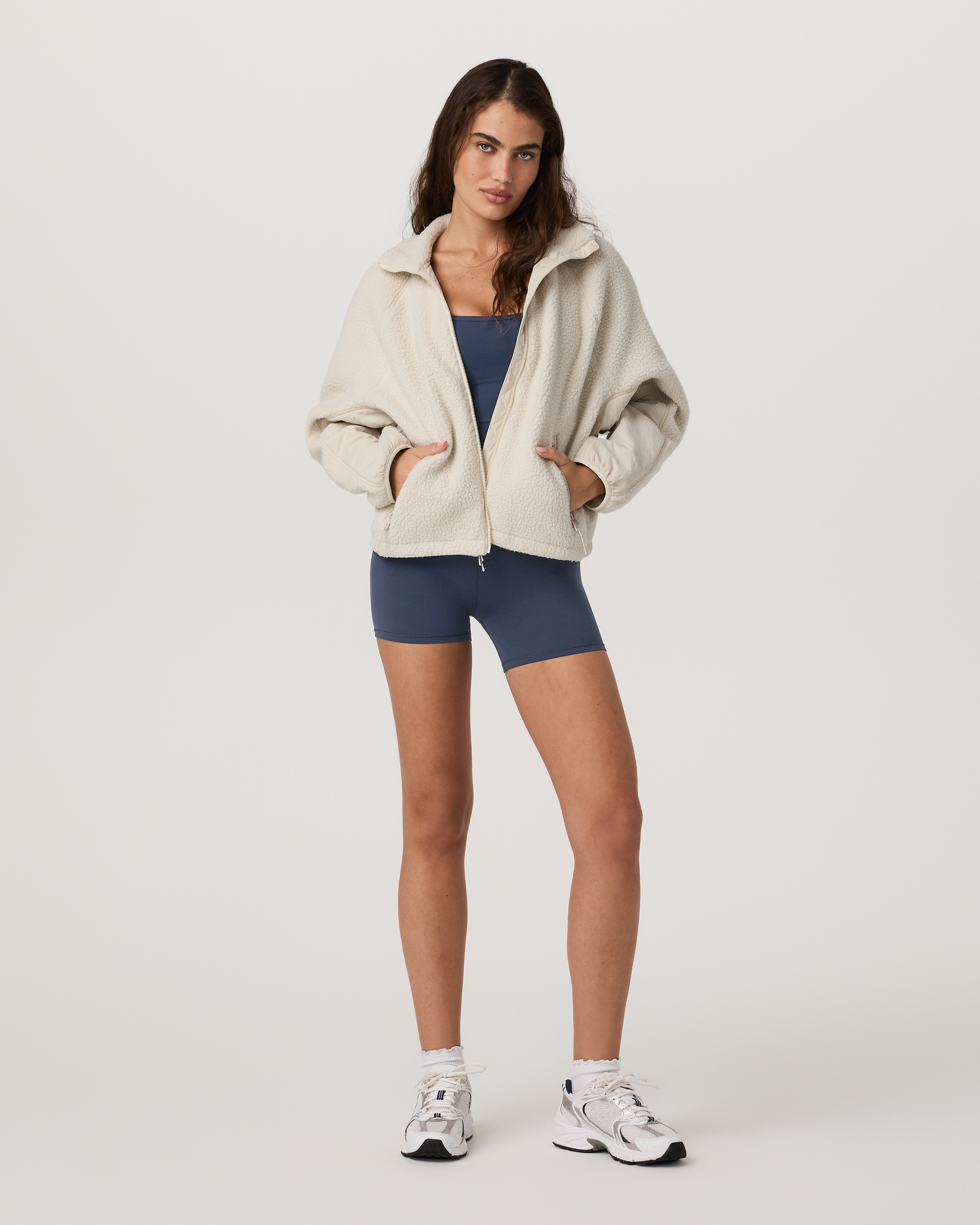 Women's oversized sherpa fleece zip-up jacket with high collar, front view on model