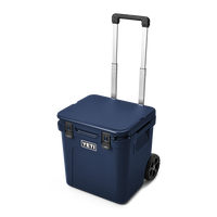 Rolling wheeled cooler with extended handle and two wheels, three-quarter front view