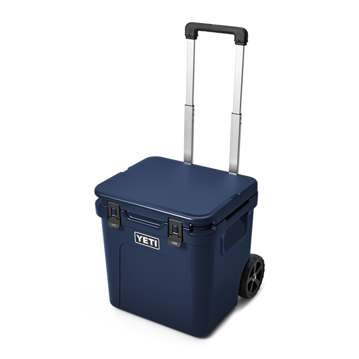 Rolling wheeled cooler with extended handle and two wheels, three-quarter front view
