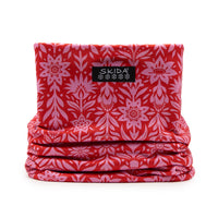Red and pink floral patterned neck gaiter folded flat, front view with brand label visible