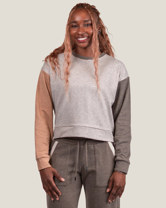 Women's colorblock fleece crewneck sweatshirt in beige and taupe tones, front view on model