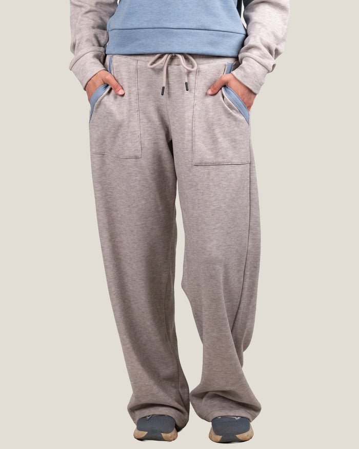 Wide-leg fleece sweatpants with drawstring waist, front patch pockets, and blue contrast pocket trim, front view