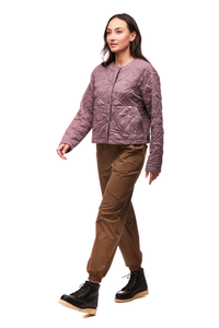 Women's quilted collarless jacket in dusty mauve with geometric stitching, front three-quarter view