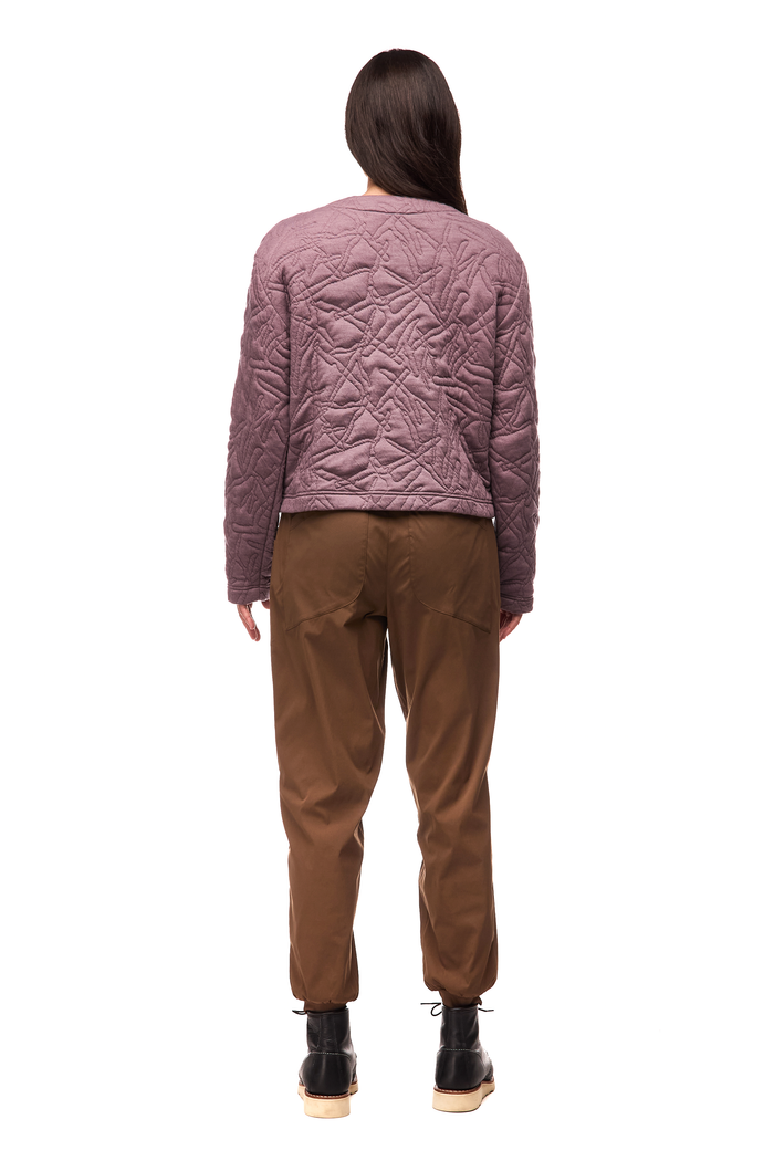 Women's quilted jacket in dusty mauve, back view, with abstract stitch pattern