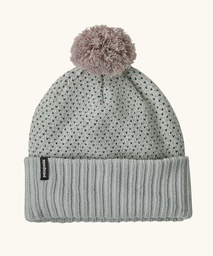 Kids' knit beanie with speckled pattern, ribbed cuff, and fluffy pom-pom on top, flat lay view