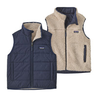Reversible kids vest showing both sides: navy quilted exterior and cream sherpa fleece interior