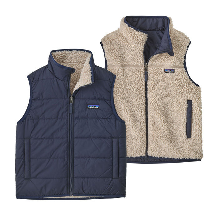 Reversible kids vest showing both sides: navy quilted exterior and cream sherpa fleece interior