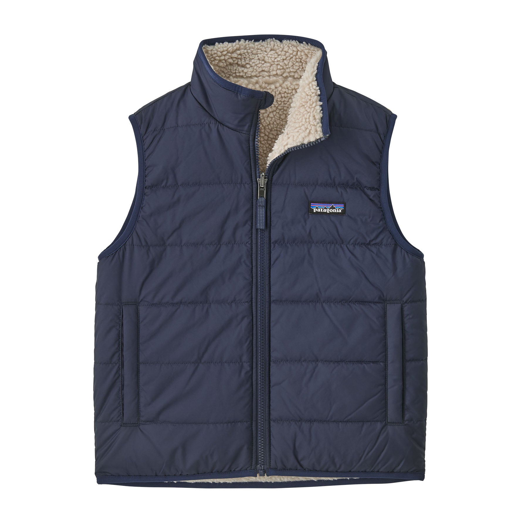 Reversible kids' vest with quilted navy exterior and cream sherpa fleece lining, full-zip front