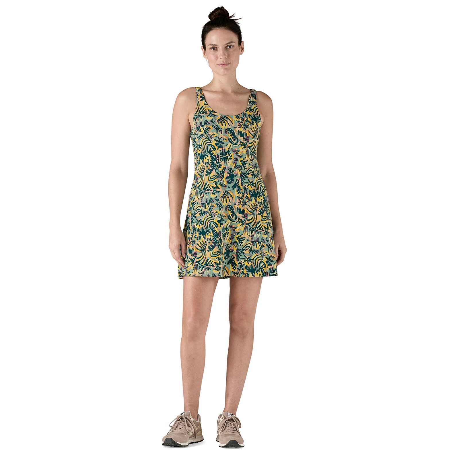 Sleeveless A-line dress with colorful paisley pattern, worn by woman in studio setting