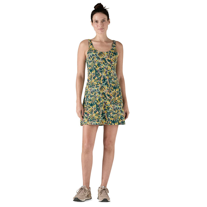 Sleeveless A-line dress with colorful paisley pattern, worn by woman in studio setting