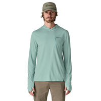 Light green hooded long-sleeve shirt with chest pocket and drawstrings, front view on model