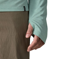 Light green long-sleeve hooded shirt with thumb holes, shown from side angle