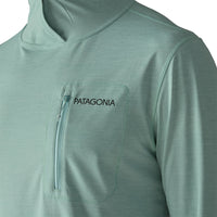 Sage green hooded sun shirt with chest zip pocket, front detail view