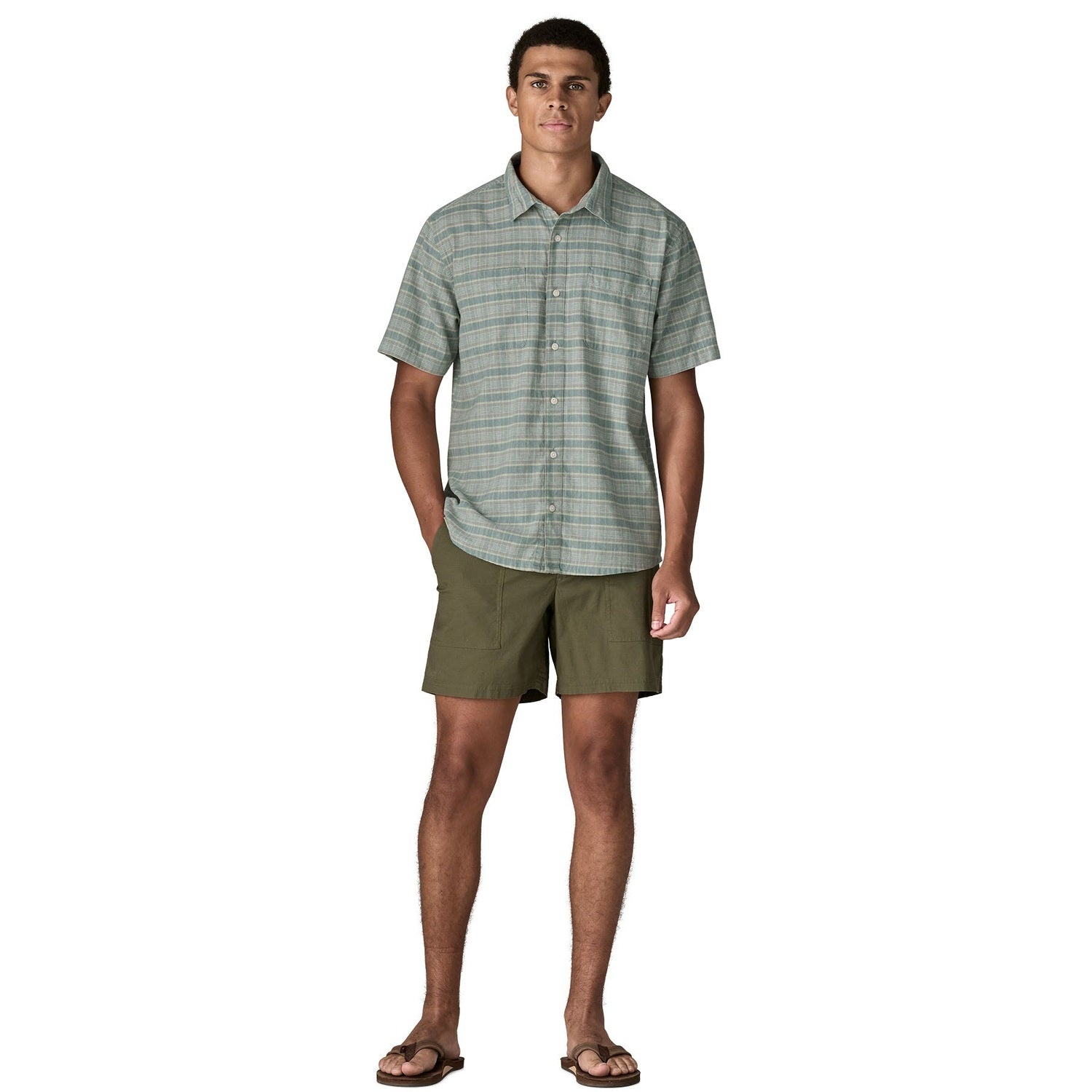 Light green plaid short-sleeve button-up shirt worn with olive green shorts, full body view