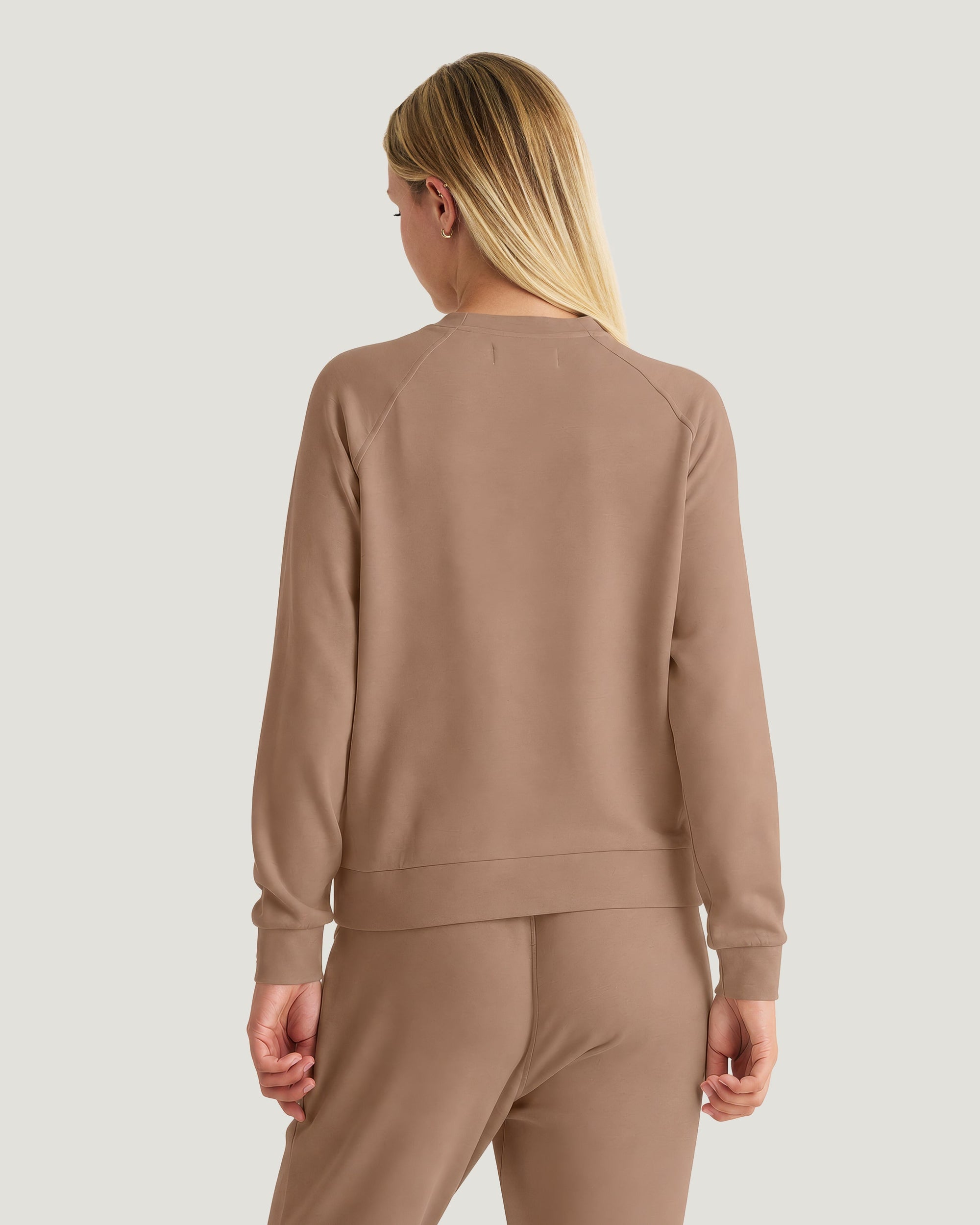 Women's lightweight fleece crew sweatshirt in warm taupe, back view on model