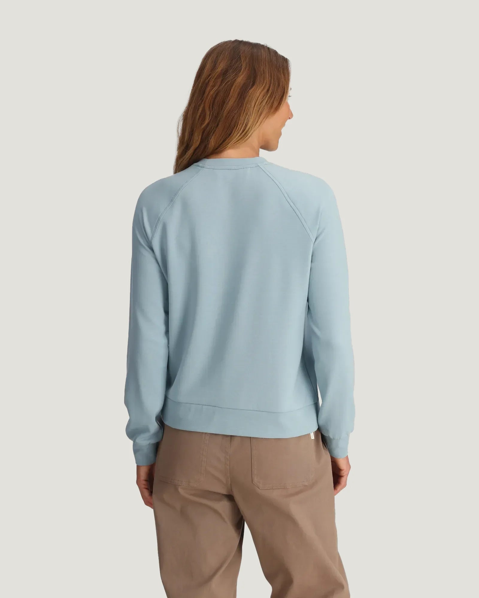 Women's light blue crewneck sweatshirt, back view, with raglan sleeves and ribbed hem