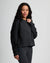 Woman wearing dark fleece crew sweatshirt with ribbed cuffs and hem, three-quarter view