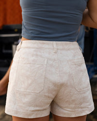 Light colored twill shorts with tropical leaf print, back view showing pockets and fit