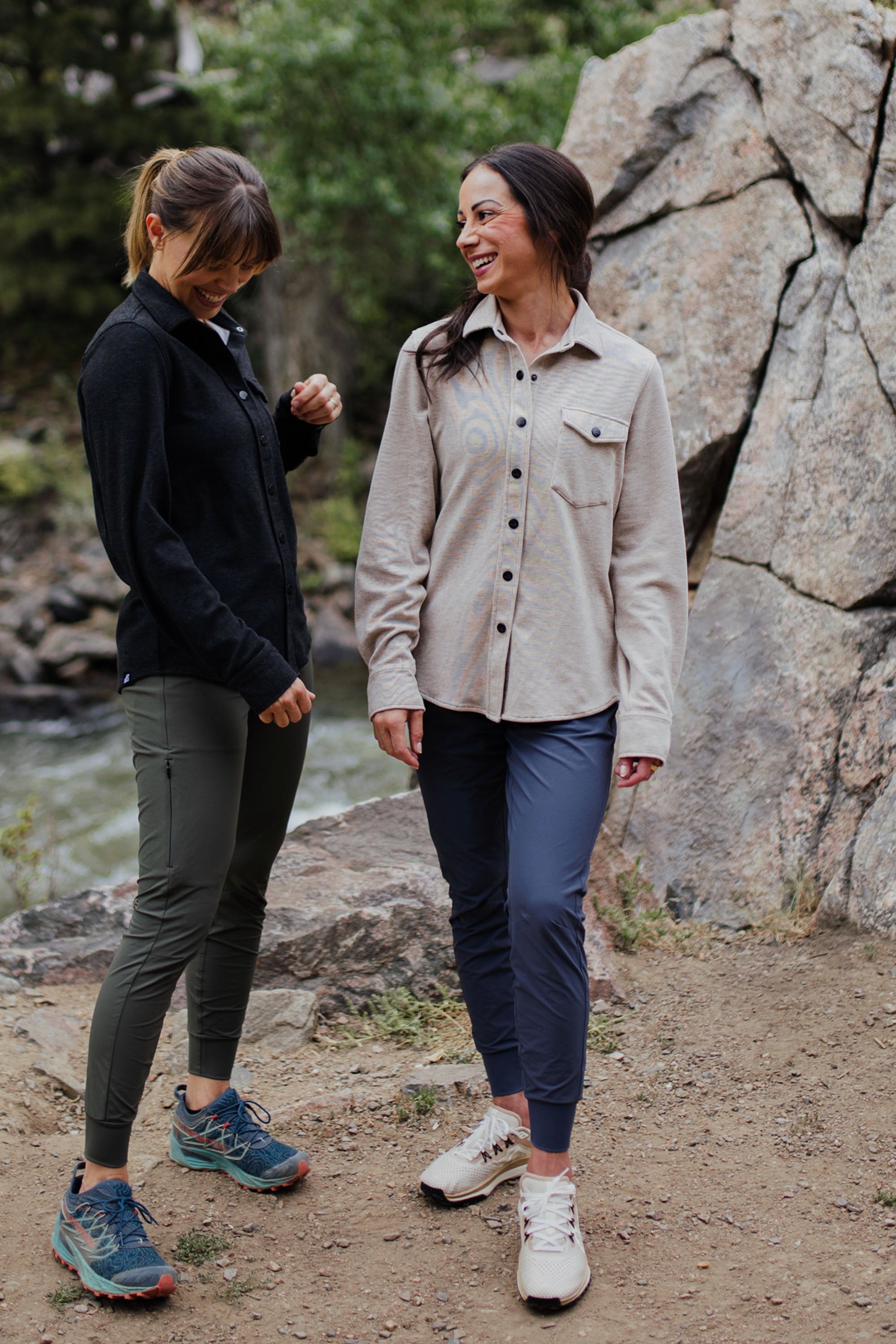 Women's fleece button-up shirt in light beige, worn open over leggings on a trail
