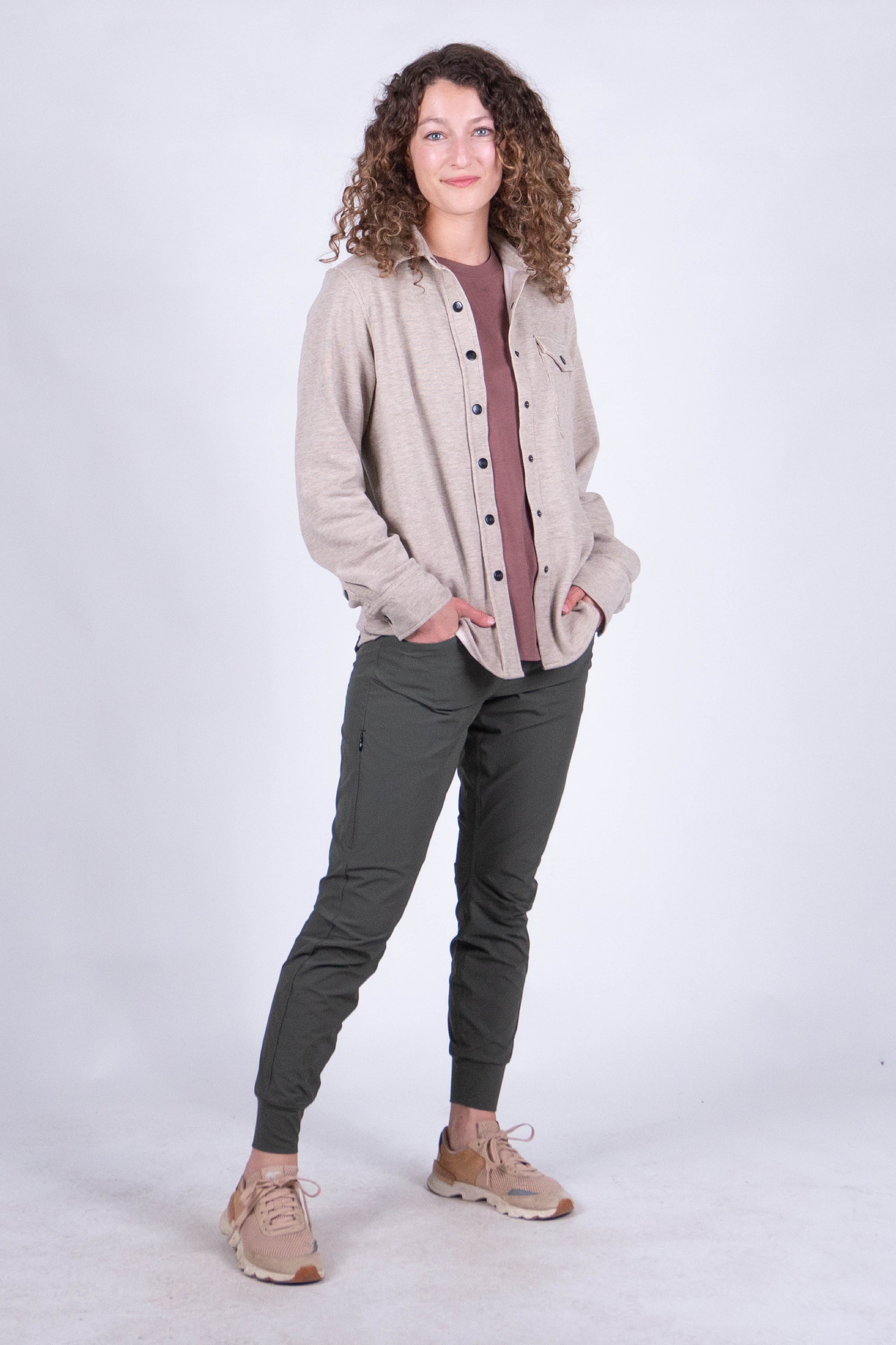 Women's fleece button-up shirt in light heathered tan, front view, on model