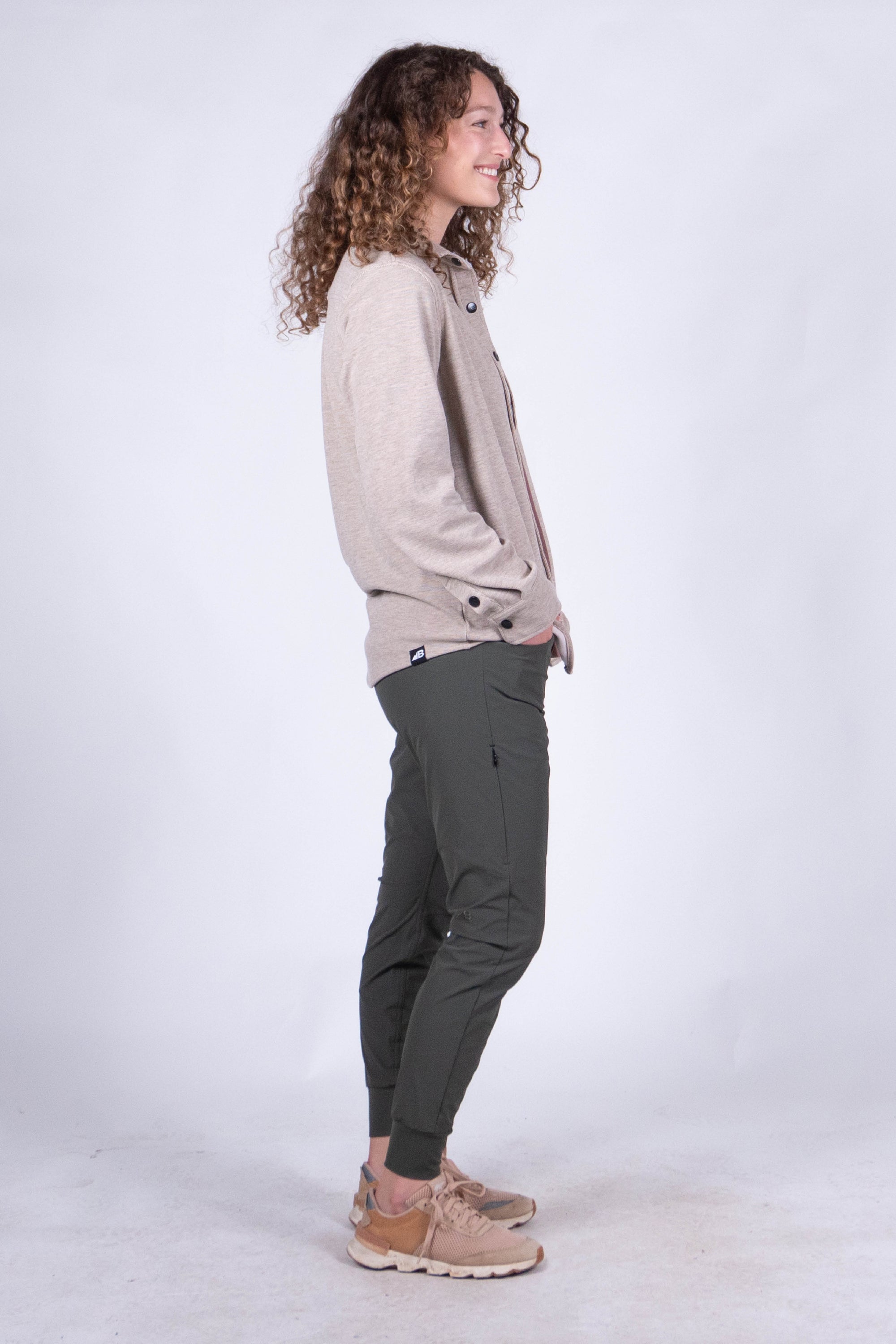 Women's fleece button-up shirt in light heathered tone, side view on model
