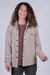 Women's fleece button-up shirt jacket in heathered beige, front view on model