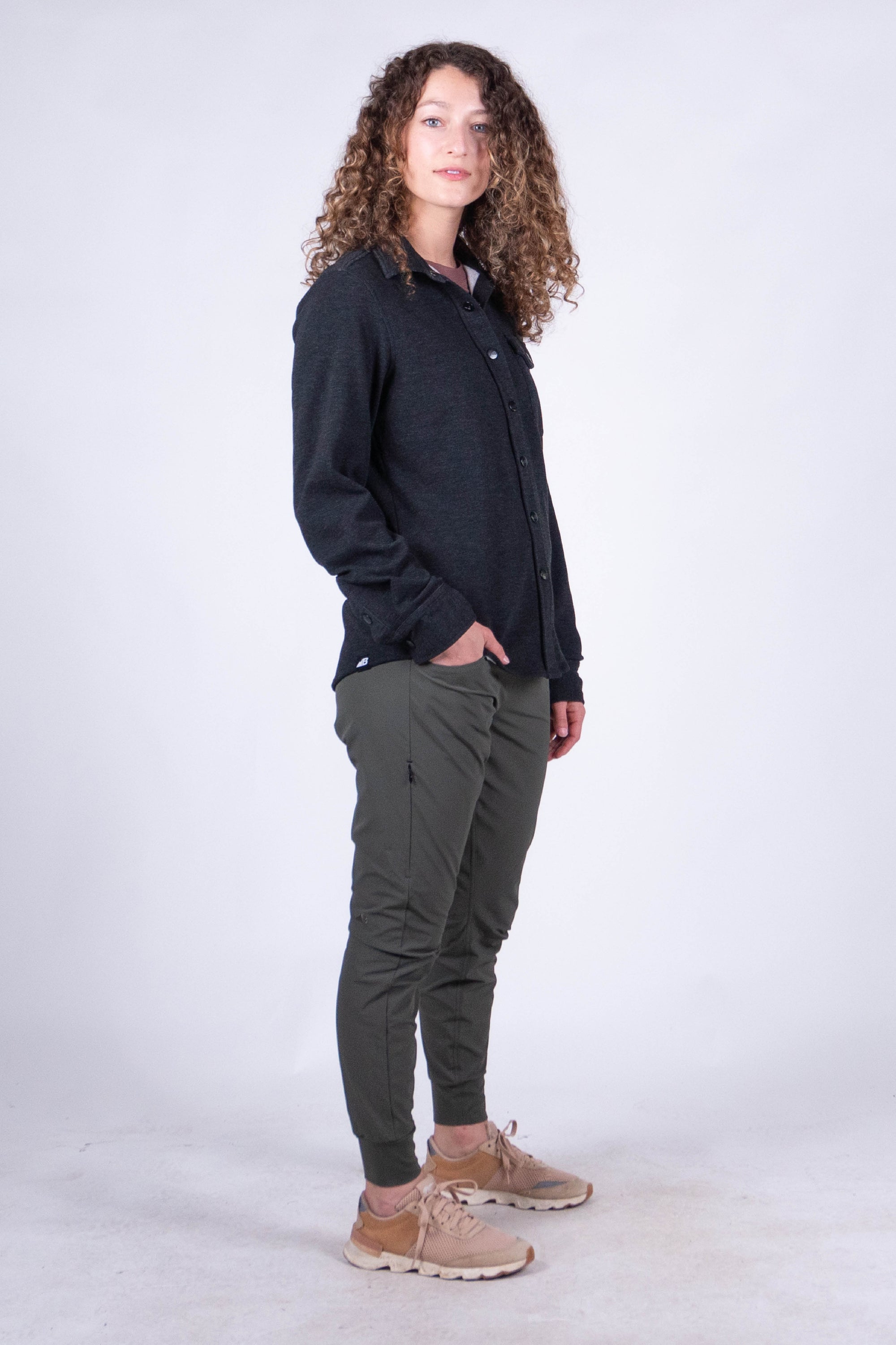 Women's fleece button-up shirt in dark color, side view, with ribbed cuffs and button placket