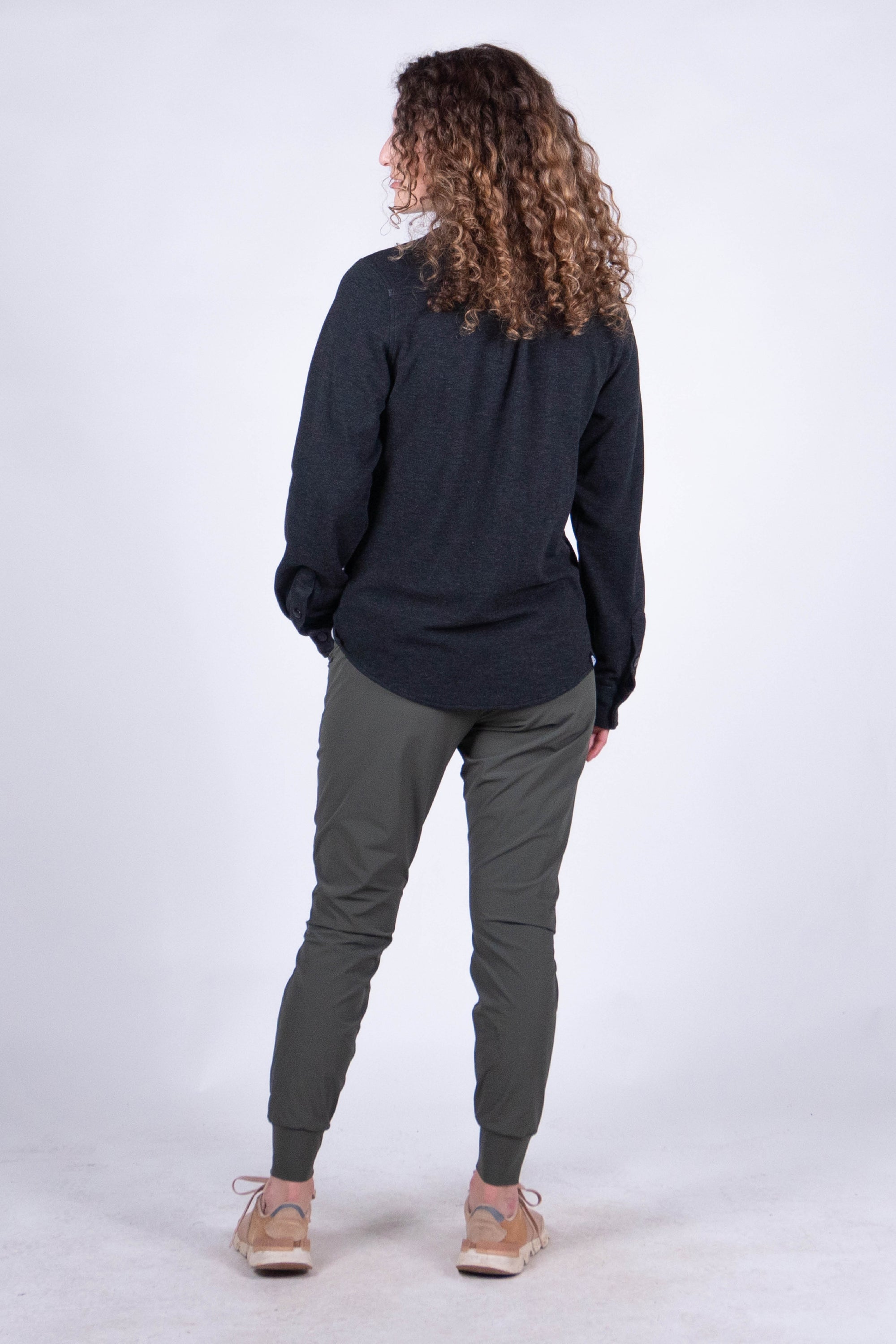 Women's long-sleeve fleece button-up shirt, back view, paired with olive jogger pants
