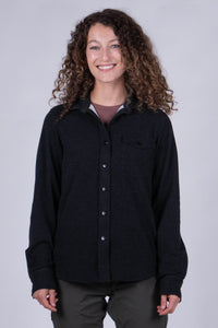 Women's fleece button-up shirt in dark charcoal with chest pocket, front view on model