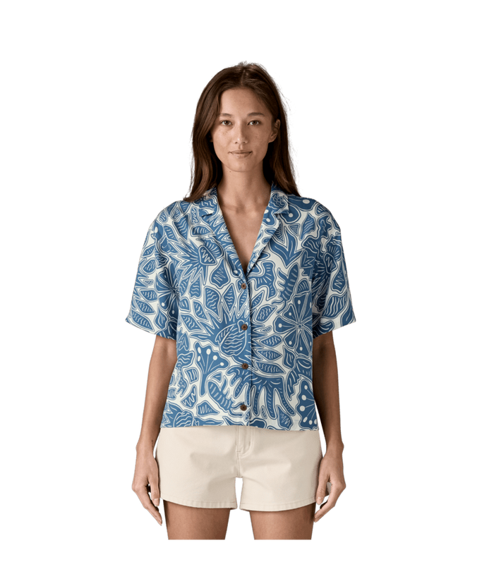 Blue and white botanical print button-up shirt with short sleeves, front view on model