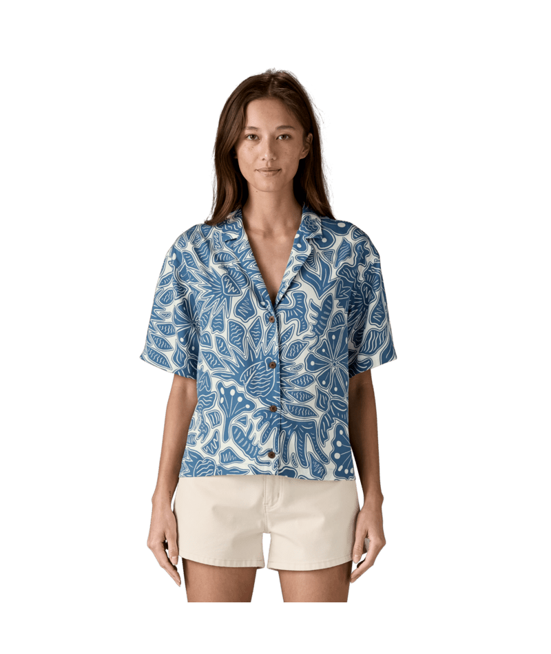 Blue and white botanical print button-up shirt with short sleeves, front view on model